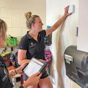  Students from Mark Hernandez’s group at the University of Colorado Boulder install an air quality monitor in a classroom. 