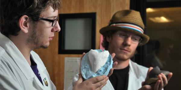 Student looking at model of a rock